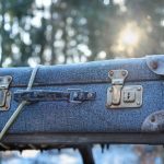 picture of a blue suitcase with some rope around it