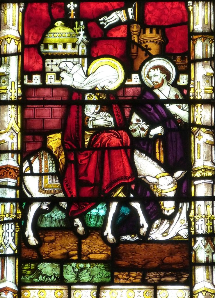 Stain glass window showing the Holy Family fleeing to Egypt